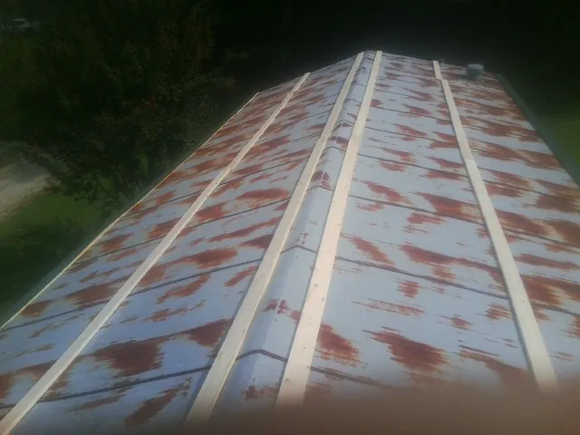 Rusted metal roof panels with new wood purlins before replacement — Storm Damage Roof Repair in Hegins by Roofing Brothers