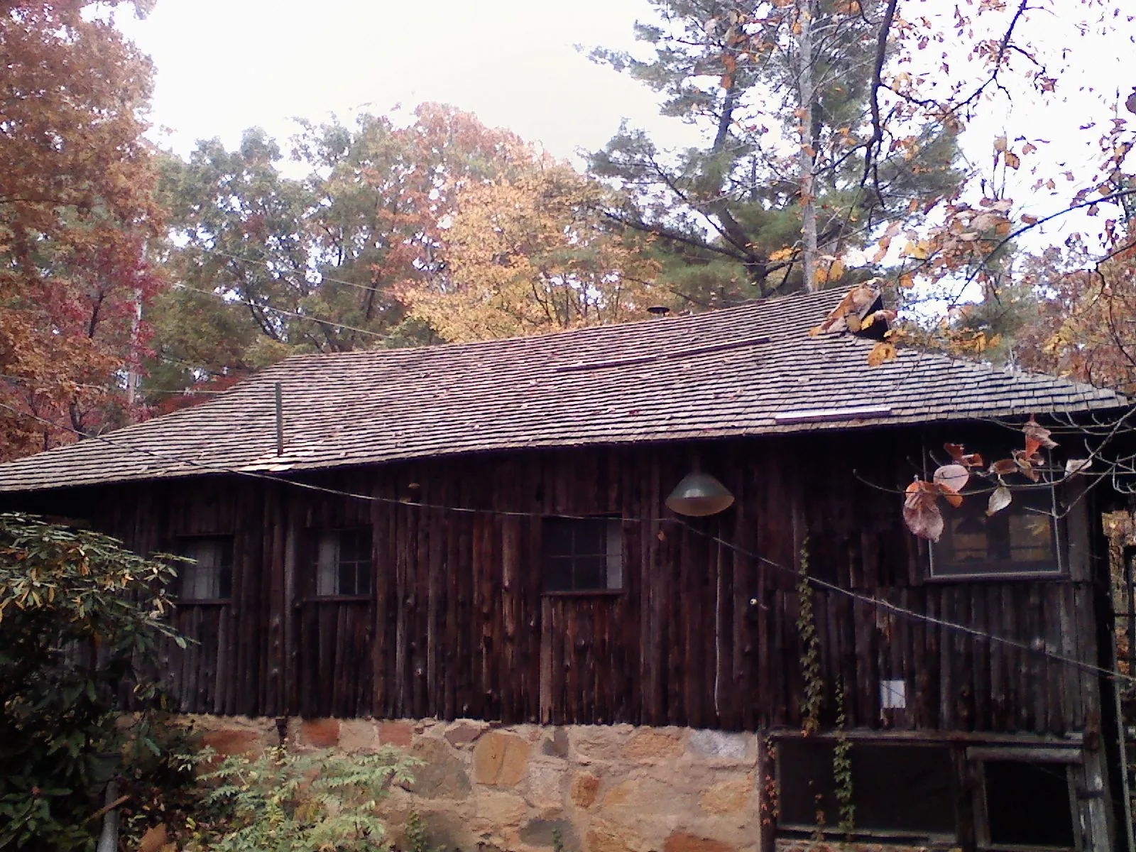 Weathered wood shake roof on a rustic board sided cabin in Hegins