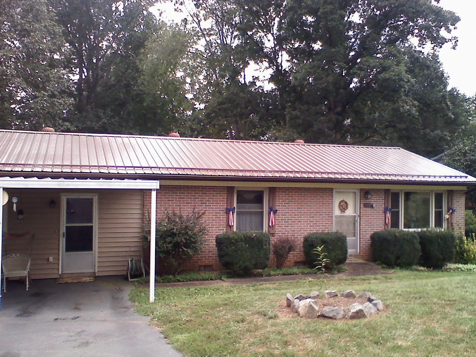 Bronze metal roof and carport on a brick ranch home — Roof Repair work by our crew in Hegins